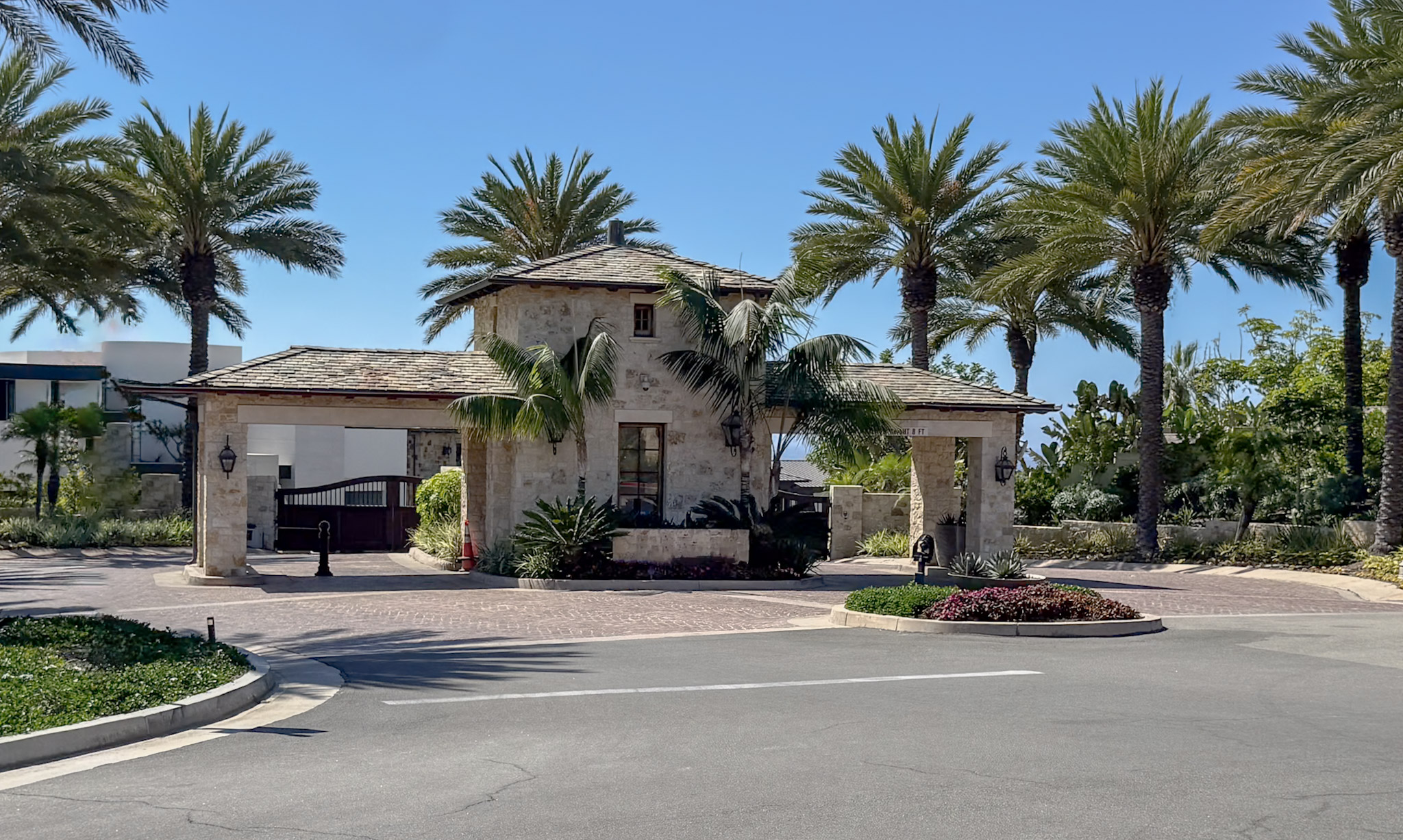 A security guard using a tablet to check in a guest.